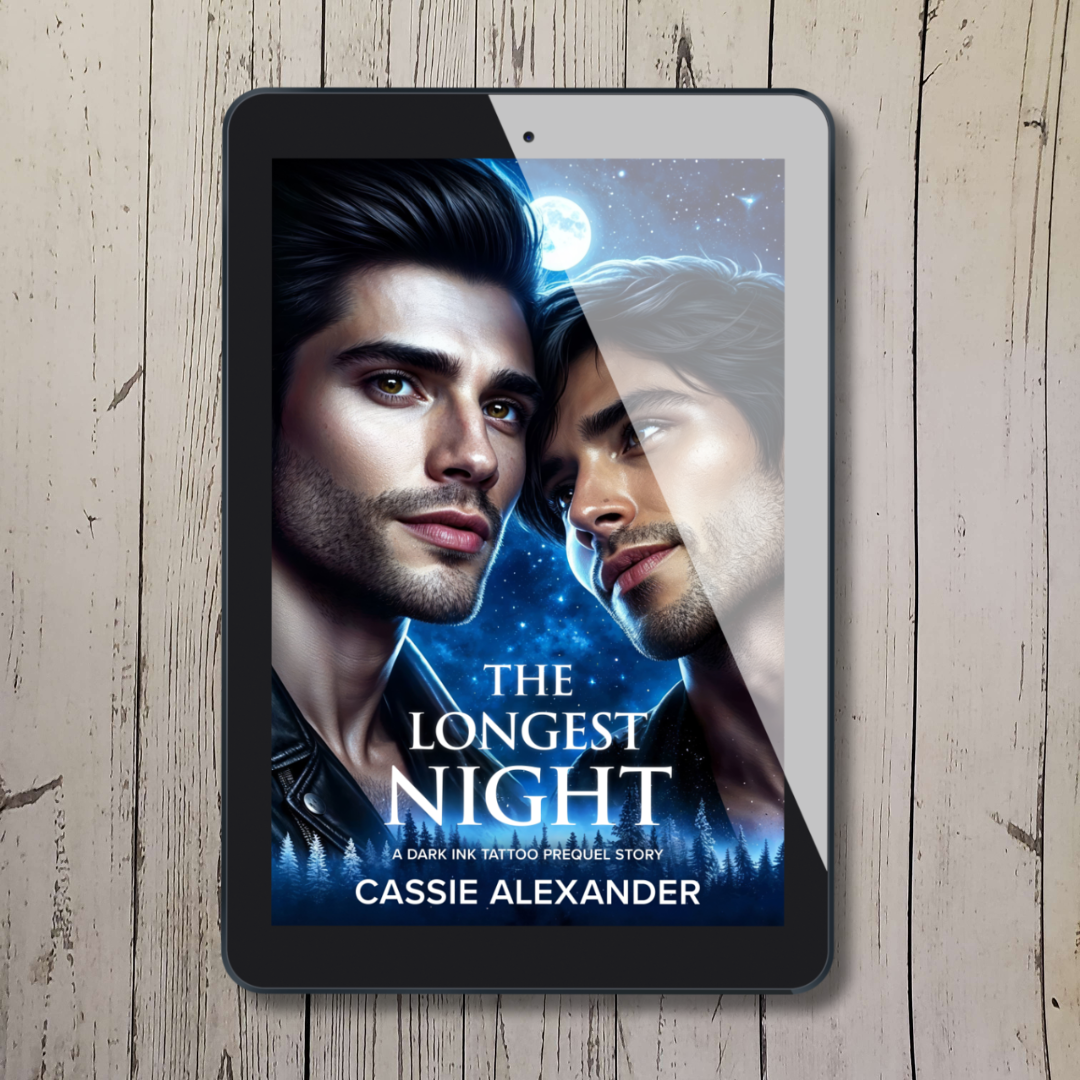Tablet showing cover of "The Longest Night: Prequel" by Cassie Alexander with two dark-haired men leaning lovingly into each other.